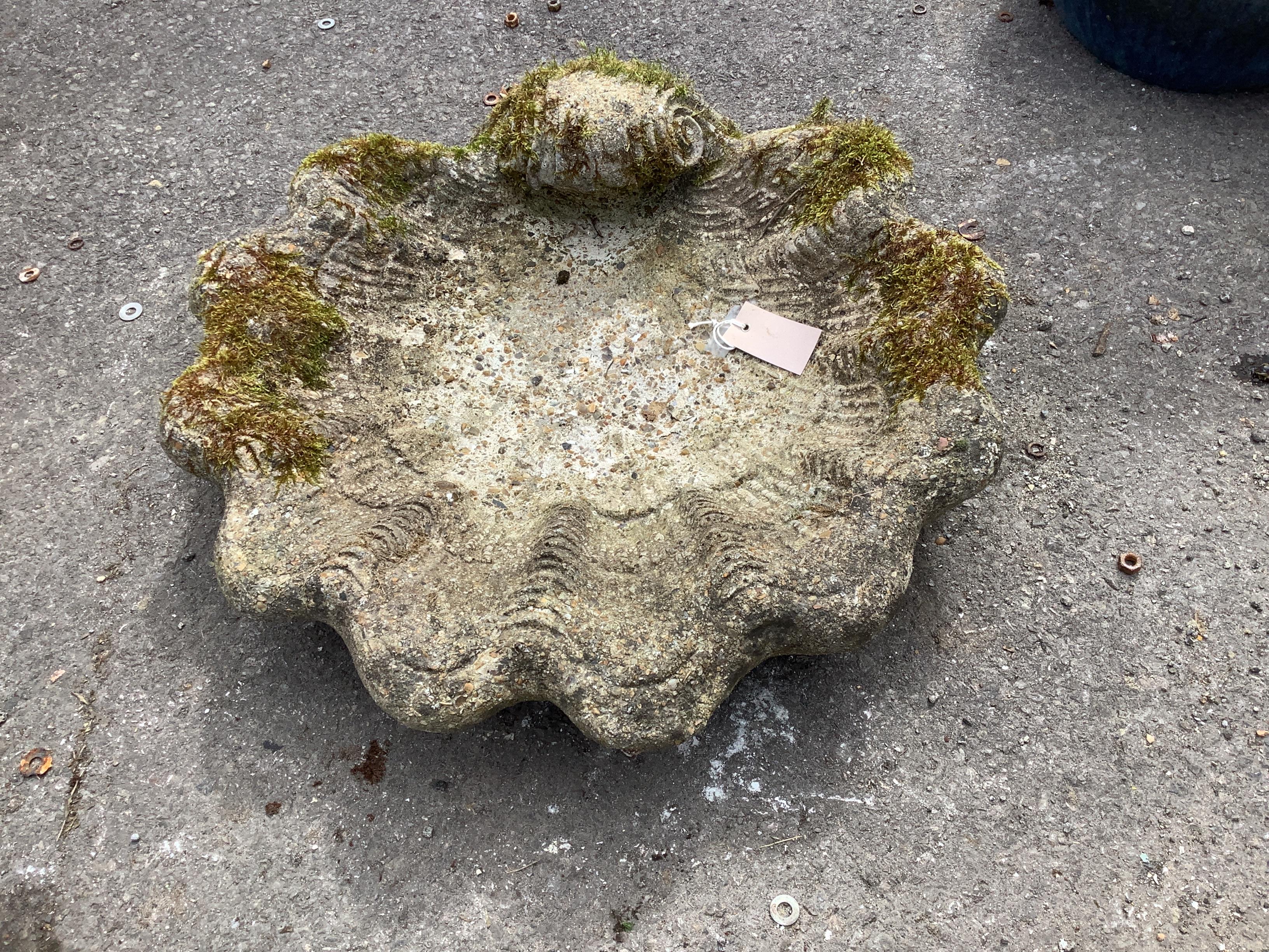 A reconstituted stone scallop shell bird bath, (missing column) width 55cm